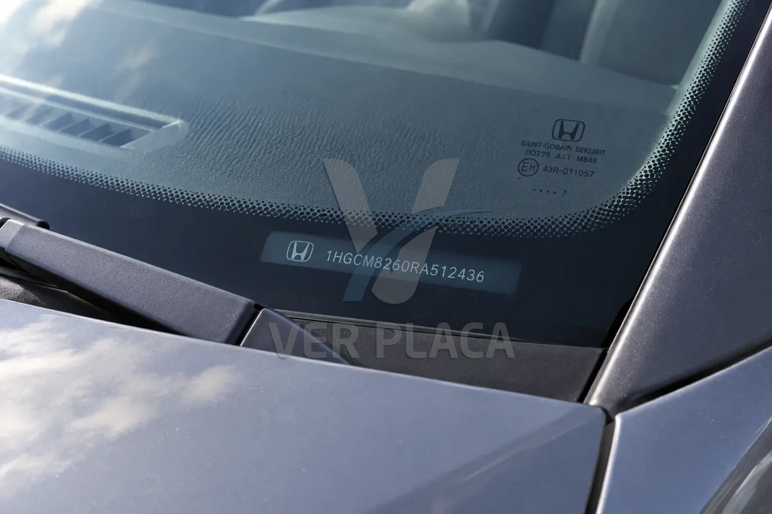 Número do chassi gravado no canto inferior do para-brisa, visível de fora do carro